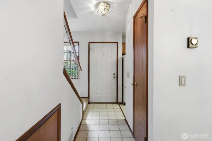 Entry way with coat closet and under stair storage on the left.