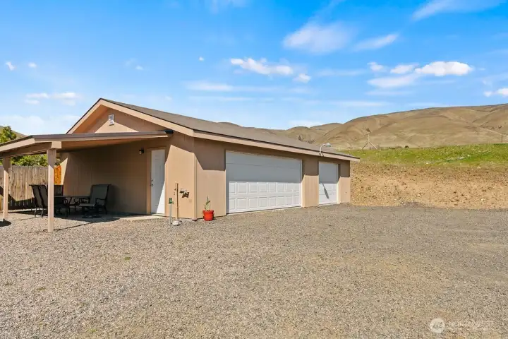 Covered entry to the shop adds convenience and versatility, creating an ideal space for workspace access, equipment storage, or weather-protected use.