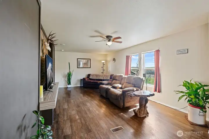 Bright and inviting living area with large windows that bring in natural light and capture peaceful outdoor views.
