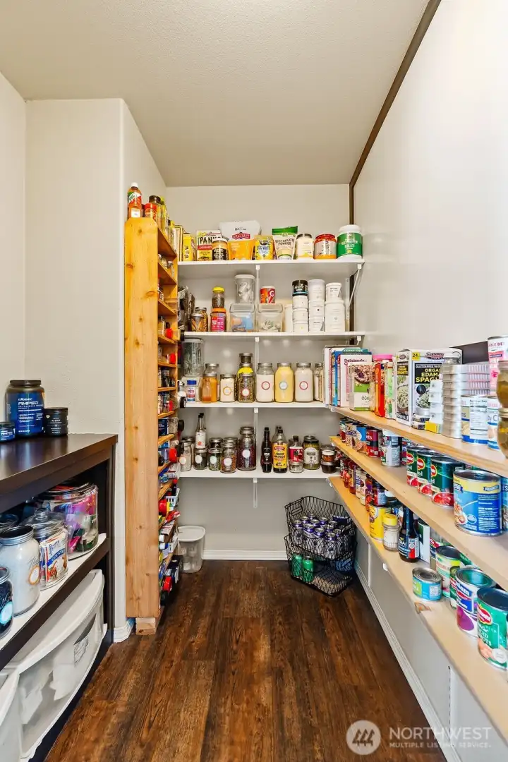 Generous walk-in pantry with built-in shelving—ideal for organized storage, bulk items, and everyday convenience.
