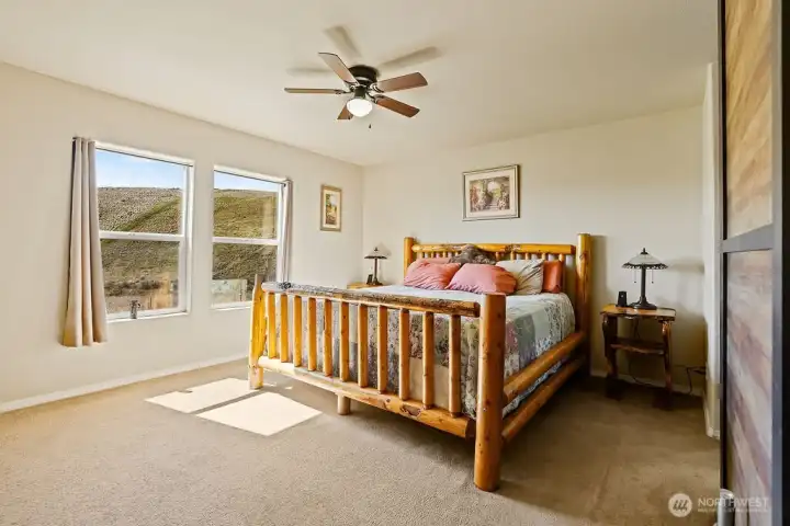 Comfortable primary bedroom with ample space, natural light, and peaceful views—designed for relaxation and retreat.