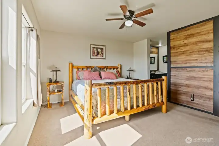 Spacious primary bedroom with a comfortable layout, natural light, and direct access to the ensuite bath for added convenience.