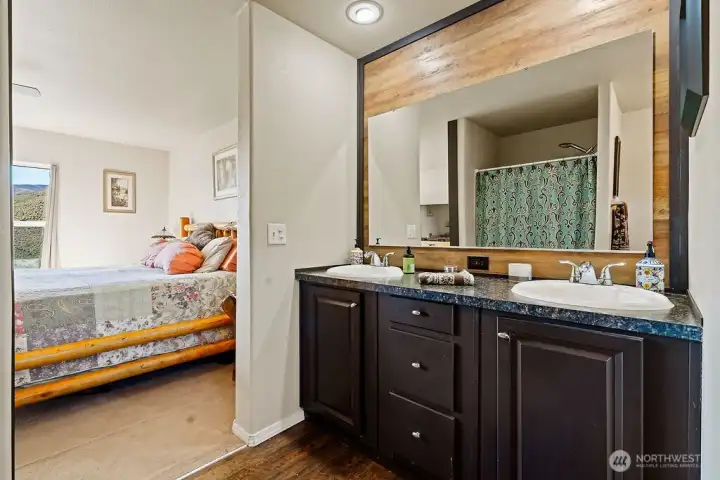 Primary ensuite featuring a dual-sink vanity with ample counter space and storage, designed for everyday functionality.