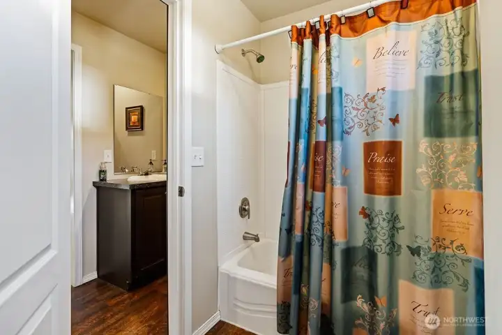 Full bathroom featuring a tub and shower combination—practical for both daily routines and guest use.