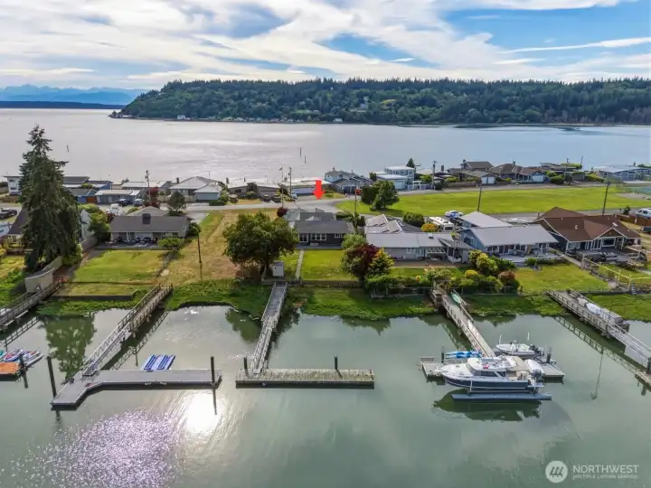 Aerial view showing the property and dock on the canal with Cultus Bay, Puget Sound and Olympic Mountains beyond. Aerial view showing the property and dock on the canal with Cultus Bay, Puget Sound and Olympic Mountains beyond.