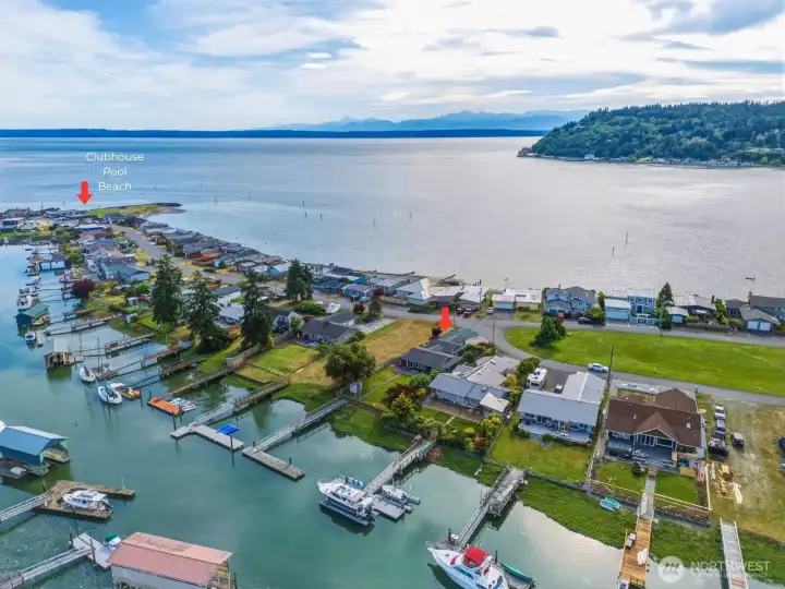 Aerial view of the home with open water toward Puget Sound and the Olympic Mountains beyond. Aerial view of the home with open water toward Puget Sound and the Olympic Mountains beyond.