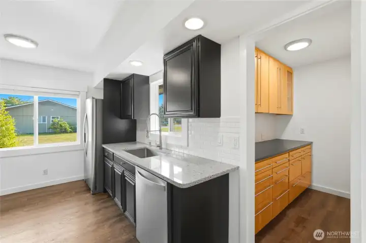 Kitchen sink area with a side yard window view, opening through to the adjoining pantry. Kitchen sink area with a side yard window view, opening through to the adjoining pantry.