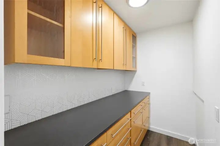 Walk-in pantry with glass-front upper cabinets, stainless pulls, and ample counter space. Walk-in pantry with glass-front upper cabinets, stainless pulls, and ample counter space.