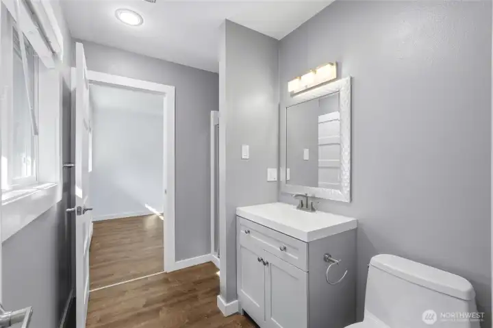 3/4 bathroom with a step-in shower behind the dividing wall, opening directly into a bedroom. 3/4 bathroom with a step-in shower behind the dividing wall, opening directly into a bedroom.