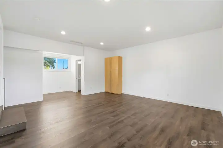 Bonus room with direct access to a 3/4 bath and a tall storage cabinet, down two steps from the main level. Bonus room with direct access to a 3/4 bath and a tall storage cabinet, down two steps from the main level.