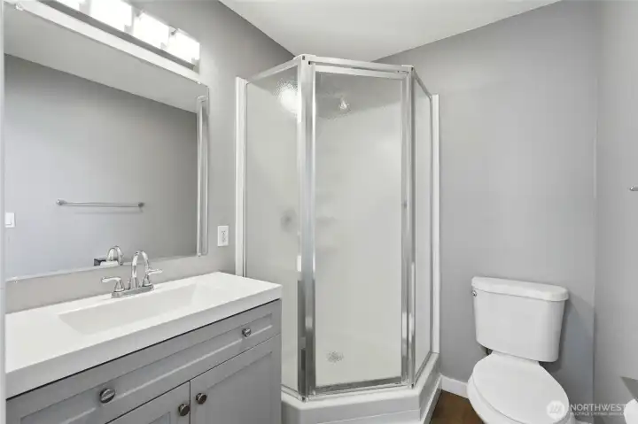 /4 bath off the bonus room, with a corner glass shower stall and gray vanity. /4 bath off the bonus room, with a corner glass shower stall and gray vanity.