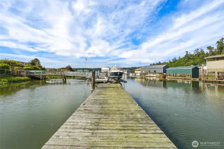 Private moorage dock with view of boathouses and canal. Private moorage dock with view of boathouses and canal.