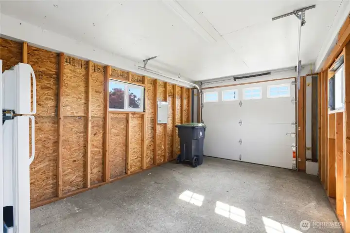 Garage interior with side windows and additional refrigerator. Garage interior with side windows and additional refrigerator.