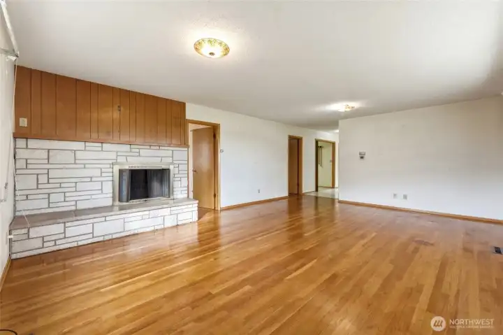 Living Room with Wood Burning Fireplace and Wood Floors