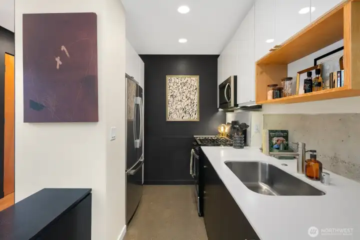 A streamlined kitchen where warm wood, polished concrete, and crisp cabinetry come together.