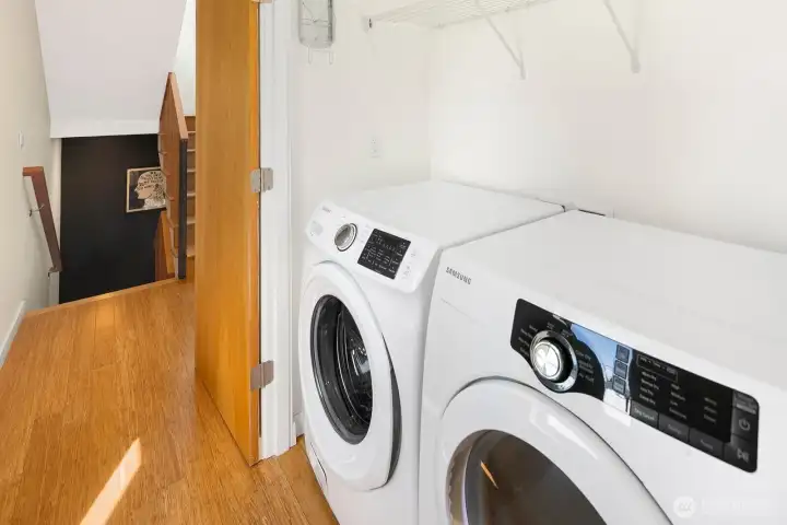 Full-size laundry with additional storage, conveniently located between the bedrooms on the second level.