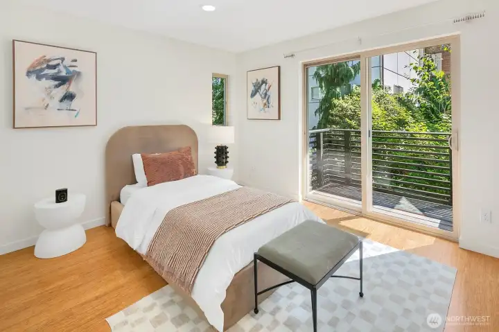 An inviting bedroom filled with natural light and garden views.