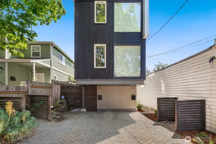 Modern architecture with striking curb appeal and one dedicated off-street parking spot (right).