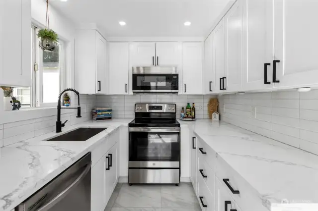 Beautiful updated kitchen with SS appliances and quartz countertops.