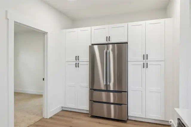 Built-in Cabinetry Surrounds the Fridge