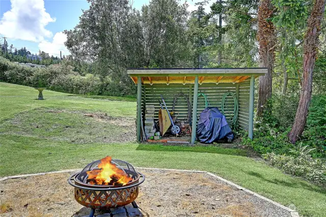 Enjoy the evenings by the fire pit with a covered outbuilding for wood logs or lawn tools