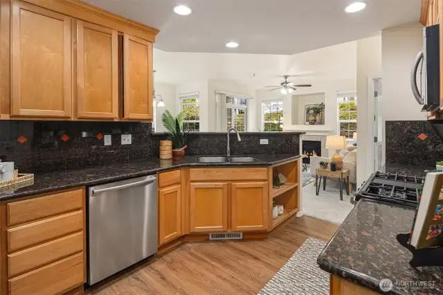 Slab granite counters and raised-panel cabinets.