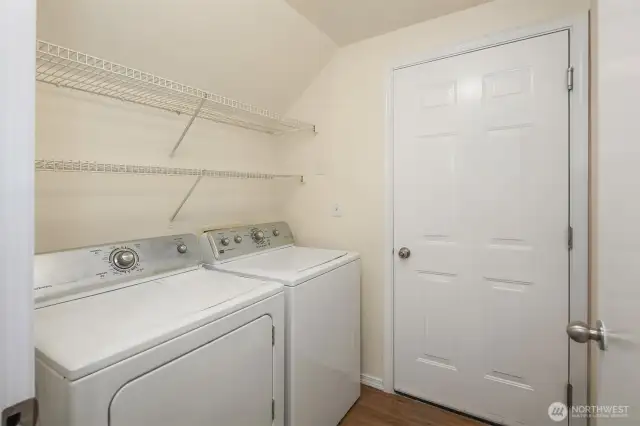 The laundry room sits between the attached garage and the kitchen.