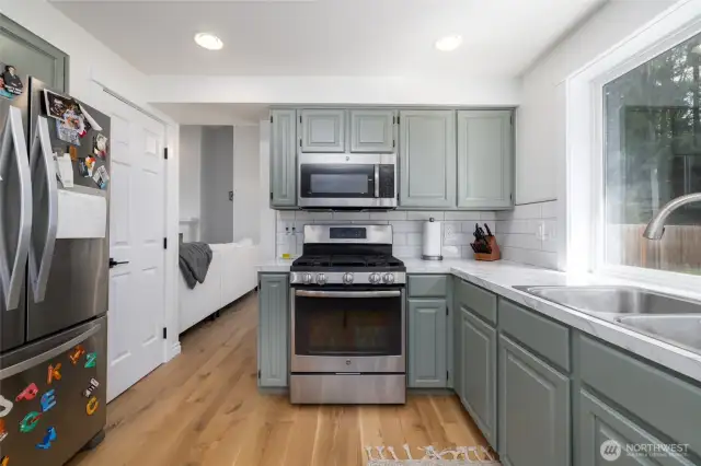 to the left of the photo, note the pantry next to the fridge, and beyond that, the living/dining space