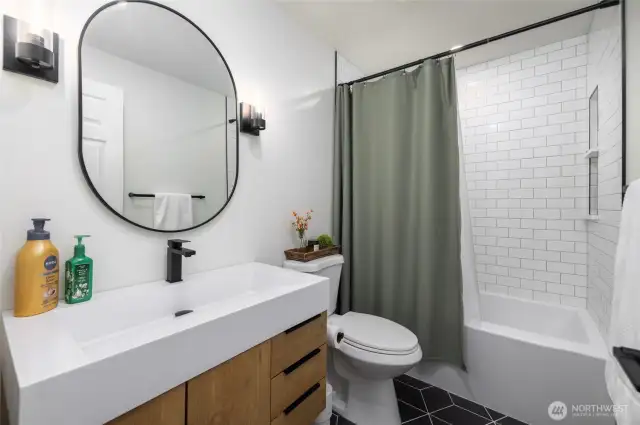2nd bathroom upstairs, also recently renovated and featuring the same clean, sleek tile work.
