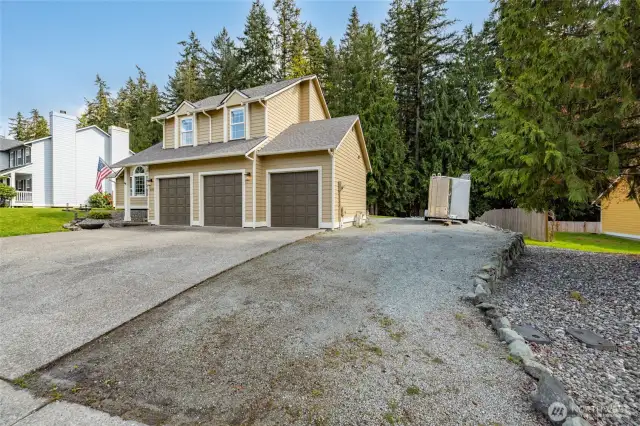 Graveled parking for boat/rv/trailer, and check out the huge 3-bay garage with room for a workshop!