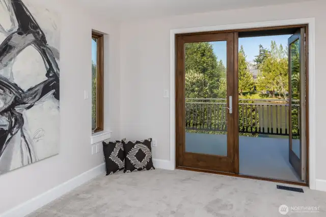 Primary Bedroom Doors to Deck Overlooking Lake