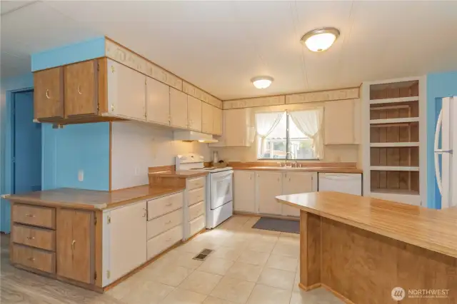 Kitchen has plenty of storage and counter space for the chef in the home