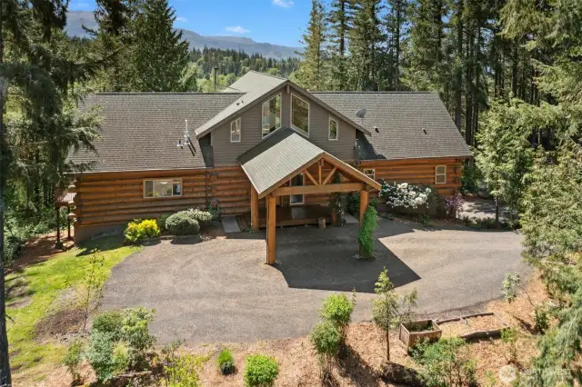 Exquisite log cabin home sitting on two tax lots, totaling 5.68 acres, with 200+' of waterfront on Winters Lake