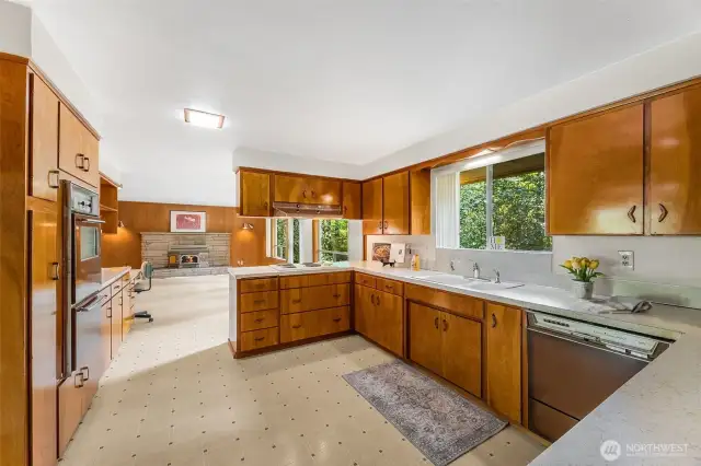 The kitchen features original appliances and original wood cabinets.