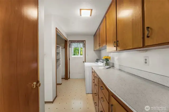 The utility room has a convenient door to the back yard.