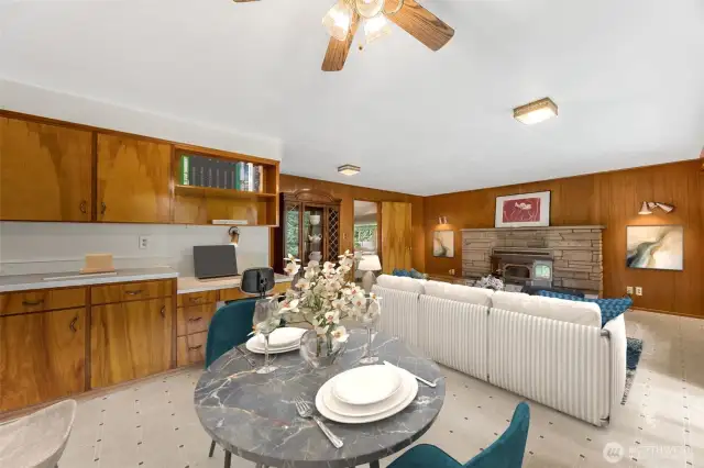Large family room off the kitchen with a wood burning fireplace. Virtually staged.
