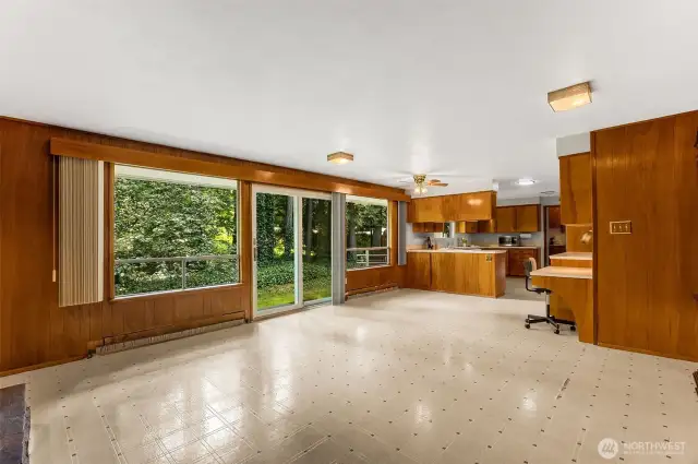 Large windows showcase the green surroundings.