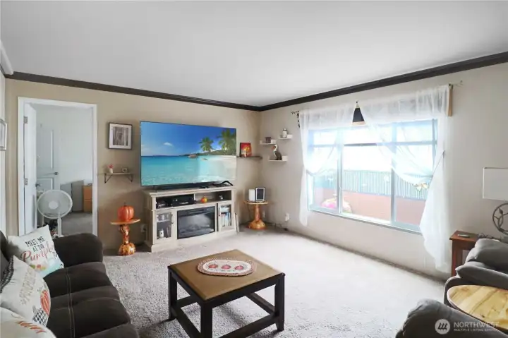 Spacious living room highlighted by a large picture window—bringing the outdoors in with abundant natural light.