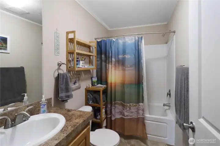Full guest bath with tub/shower combination and a clean, functional layout. Conveniently located near the bedrooms.