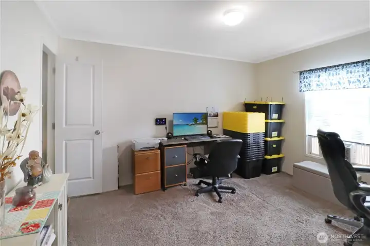 Comfortable guest room with a window for natural light and space for all your bedroom furniture including a queen size bed or home office setup.