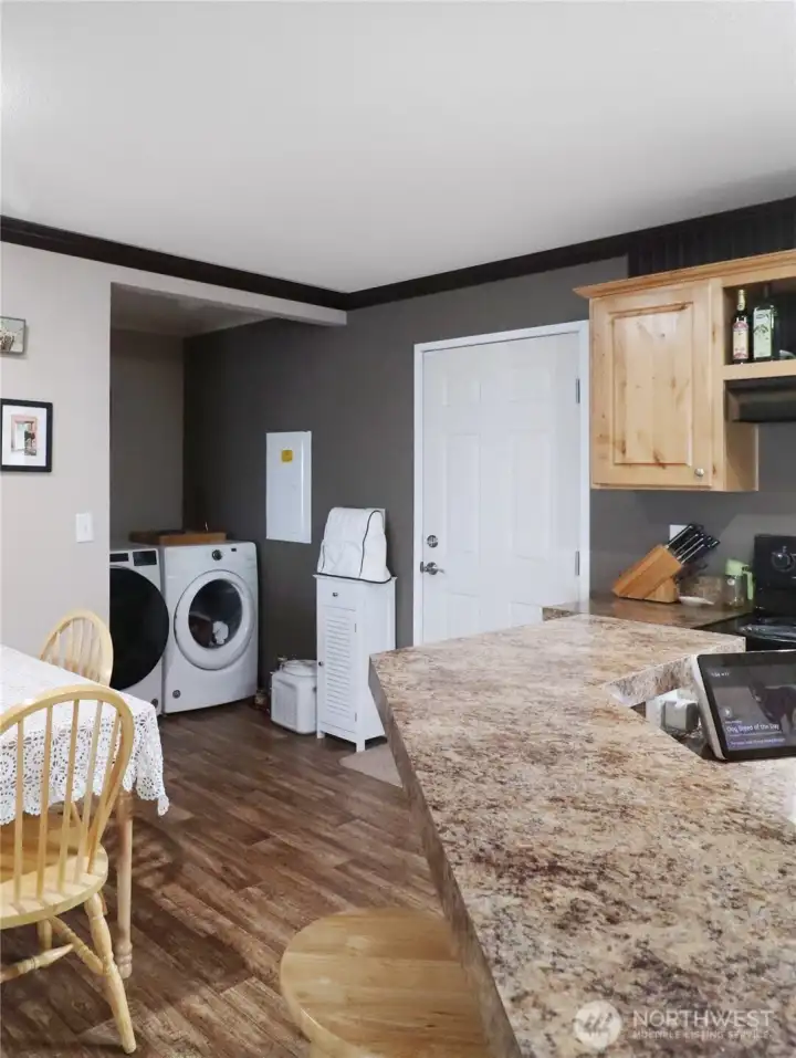 Convenient laundry room with space for storage and easy access to the outdoors, and the washer and dryer stay.