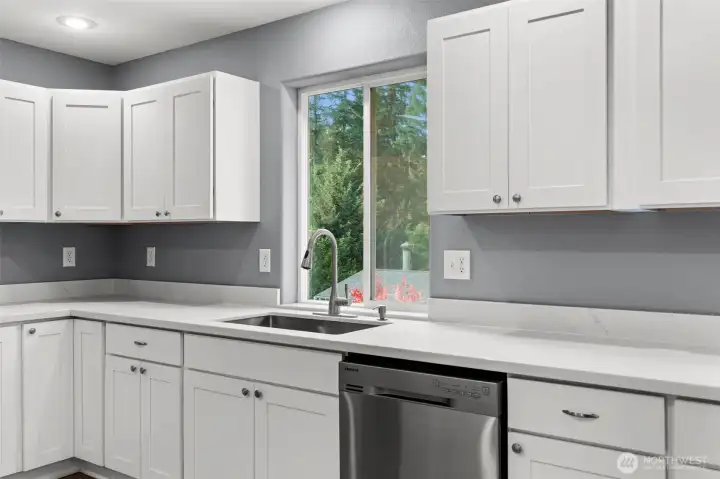 Plenty of counterspace to plan great meals and still see outside to the deck and yard.