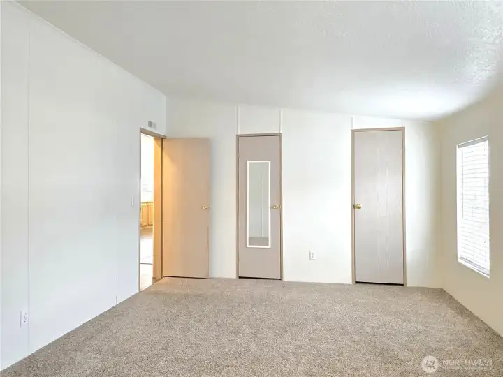 The primary bedroom has ample closet space featuring a full wall of closets.