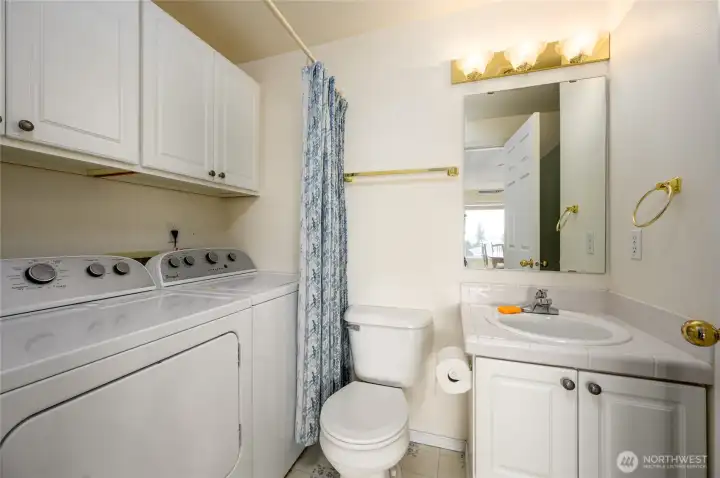 Hall bathroom with shower and washer and dryer
