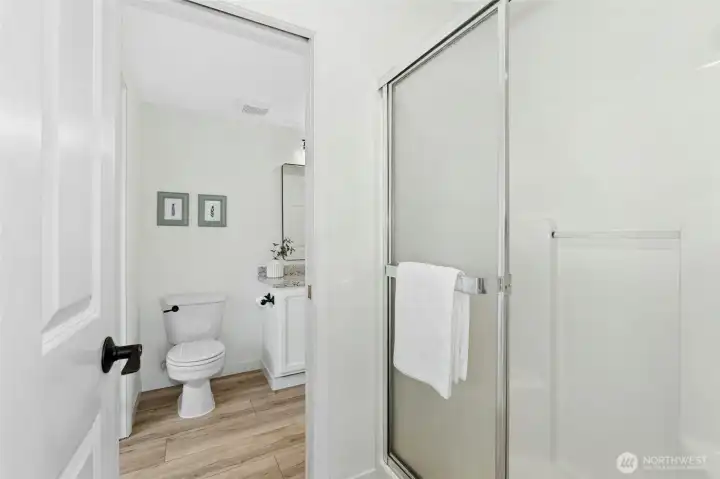Main level bath that opens to the bedroom and hall