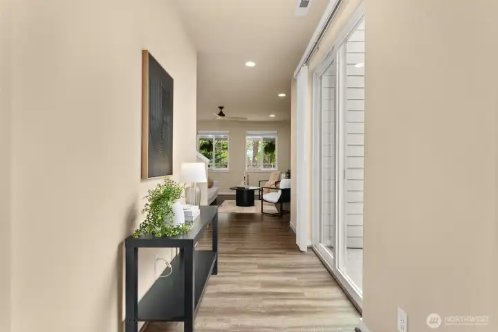 Bright entryway with sliding glass door leading to the backyard, filling the space with natural light