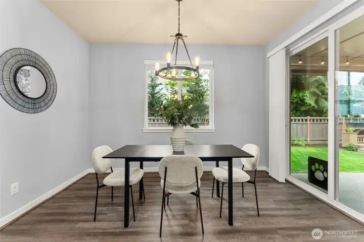 Generous dining area with ample natural light and scenic backyard views
