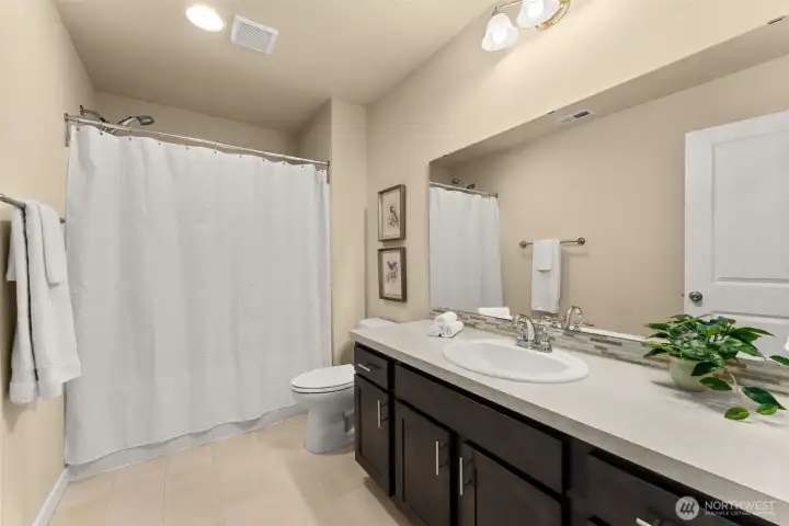Generously sized guest bath designed for comfort and functionality