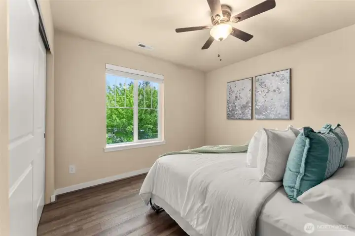 Additional guest bedroom featuring a beautiful Murphy bed (included) with front yard views