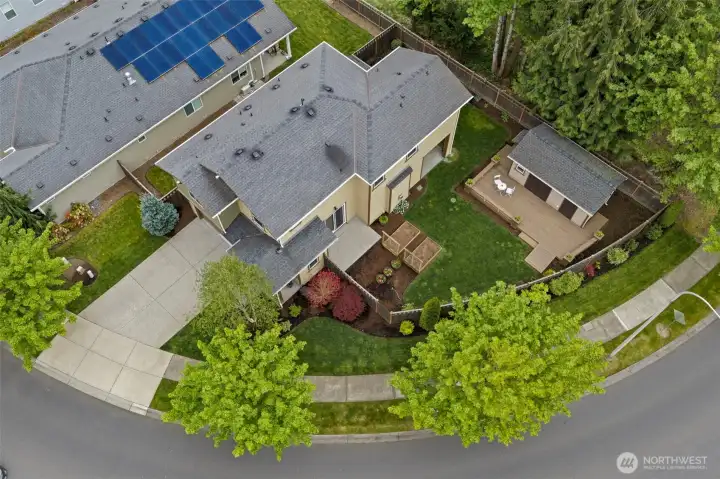 Aerial view capturing the home, custom shop, and lush, well-maintained landscaping